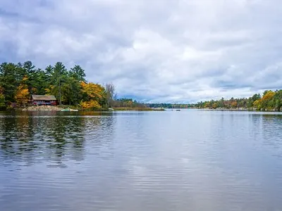 Lakeshore cottage among autumn trees in Whitestone